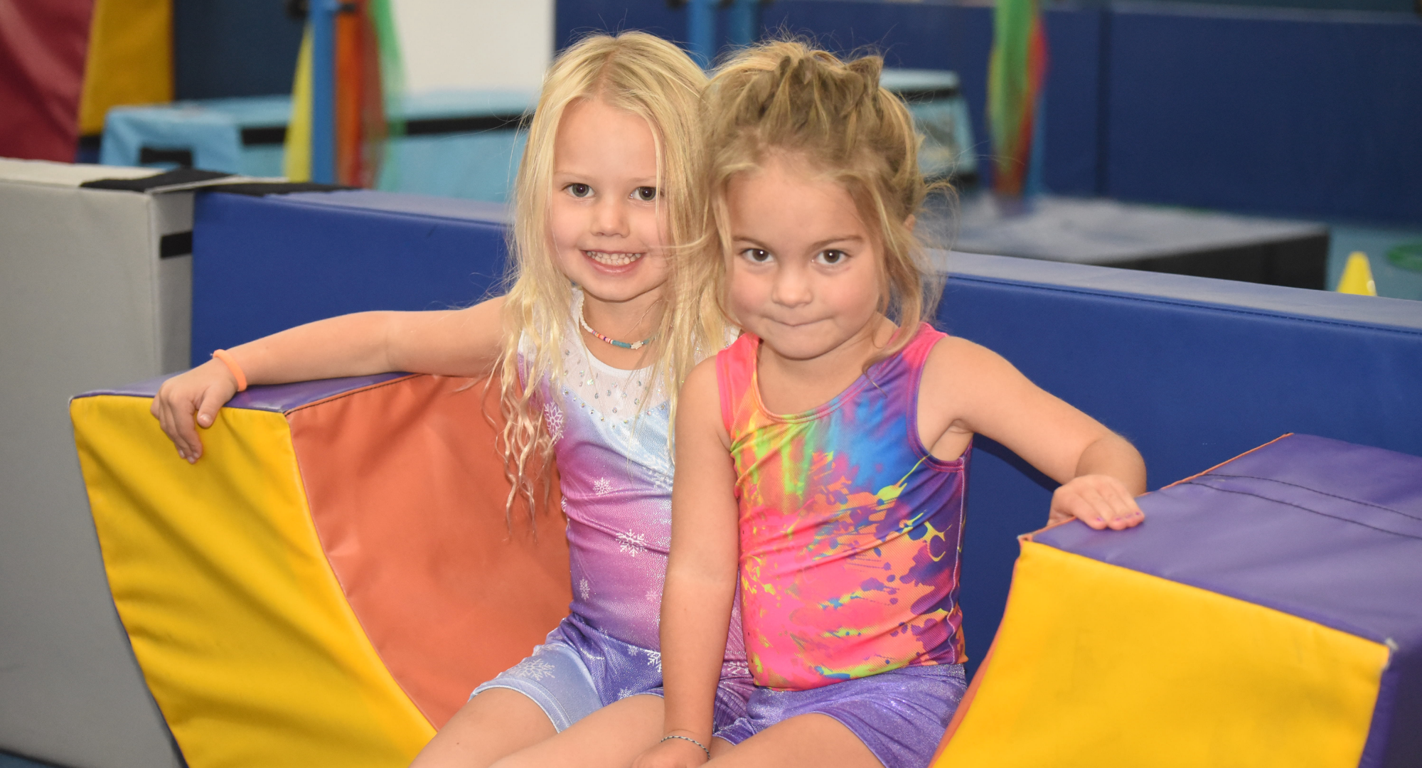 A smiling young child enjoying movement activities at Momentum Athletic Center